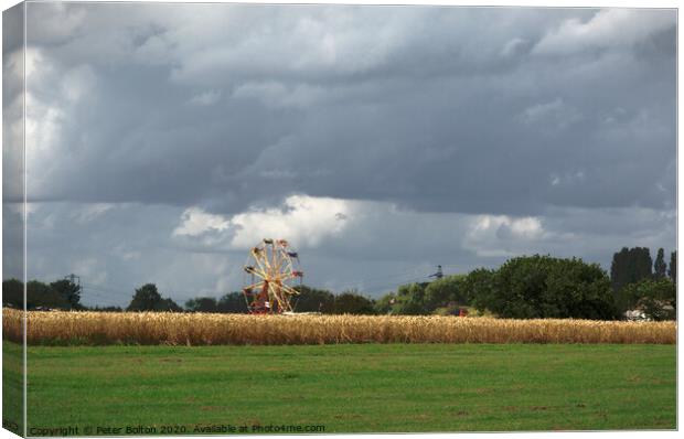 Ferris wheel at a country show viewed from across a wheat field. Damyns Hall Aerodrome, Essex, UK. Canvas Print by Peter Bolton