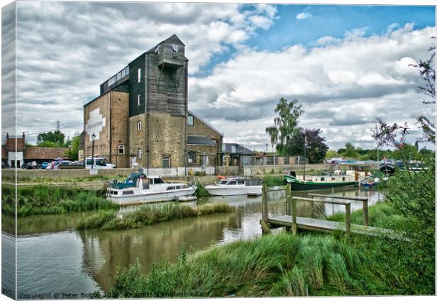 Old mill at Battlesbridge, now an antiques centre, River Crouch in foreground. Canvas Print by Peter Bolton