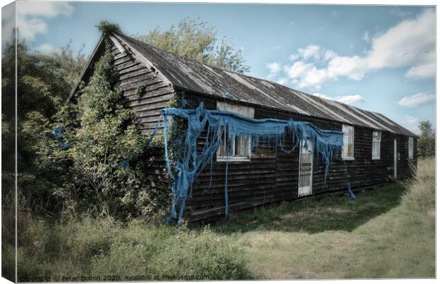 WWII abandoned barrack hut on the shore of the River Blackwater at Bradwell, Essex Canvas Print by Peter Bolton