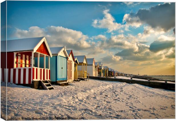 Beach huts at Thorpe Bay in winter with snow.  Canvas Print by Peter Bolton