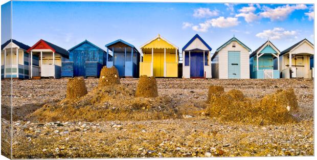 Beach huts and sandcastles at Thorpe Bay, Thames Estuary, Essex, UK. Canvas Print by Peter Bolton
