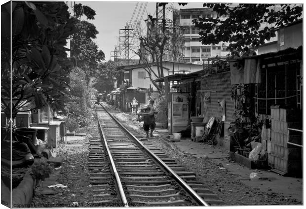 Railway track in central Bangkok, Thailand, with houses alongside. Canvas Print by Peter Bolton