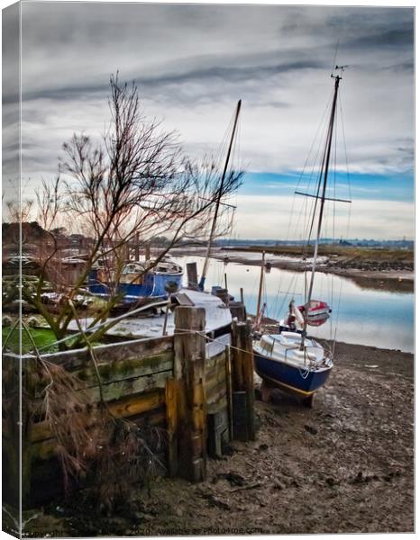 A mooring dock on the River Crouch with boats waiting for the tide. Hullbridge, Essex, UK. Canvas Print by Peter Bolton