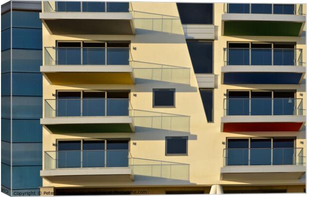 Apartments at Westcliff on Sea form abstract patterns in the sunlight . Canvas Print by Peter Bolton