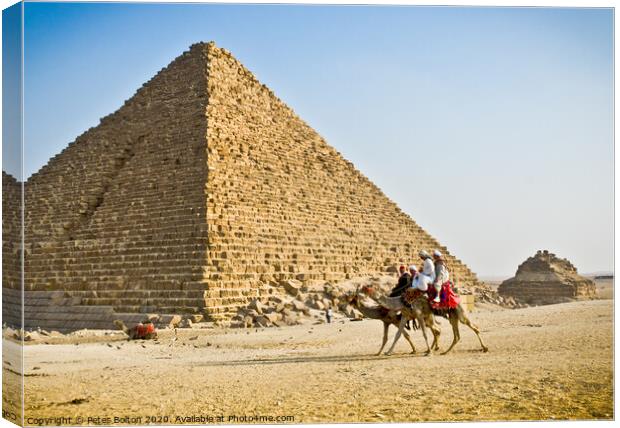 Pyramid of Menkaure with passing camels, Giza, Egypt. Canvas Print by Peter Bolton