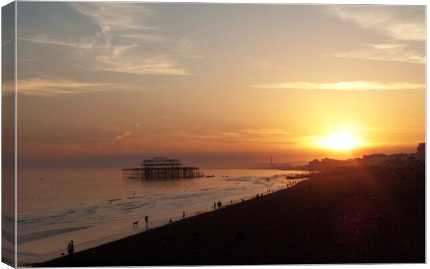 Setting sun and West Pier at Brighton, Sussex, UK. Canvas Print by Peter Bolton