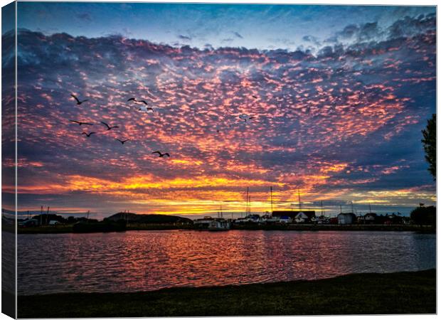 Sunset over water Canvas Print by David Buckland