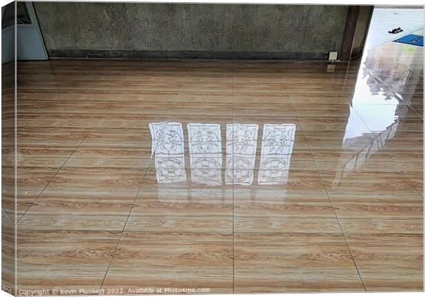 Reflected images on a shiny floor  Canvas Print by Kevin Plunkett