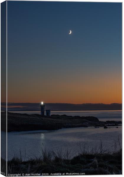 Lighthouse Beacon at Dusk on a Wintry Headland Canvas Print by Ken Hunter