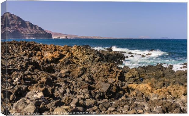 The wild rocky coastline near Orzola in Northern L Canvas Print by Michael Shannon