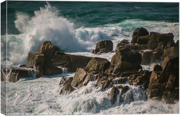 Waves crash against the rocks at Lands End, Cornwa Canvas Print by Michael Shannon