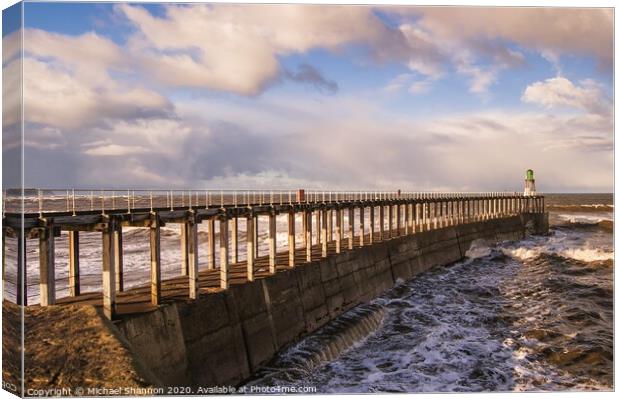 Whitby West Pier on a stormy day Canvas Print by Michael Shannon