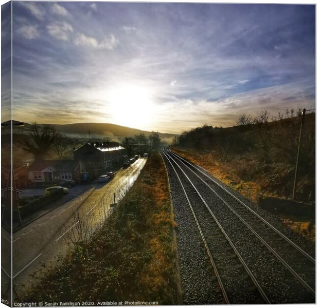 Rail and road at sunrise, Mossley Canvas Print by Sarah Paddison