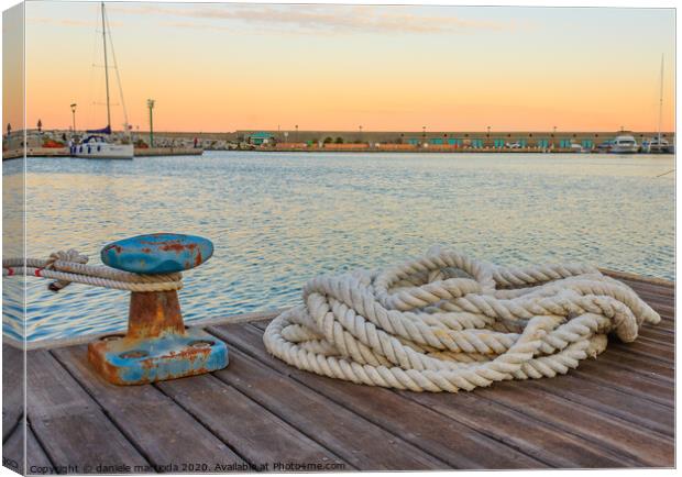 detail of a bollard with ropes for mooring at the  Canvas Print by daniele mattioda