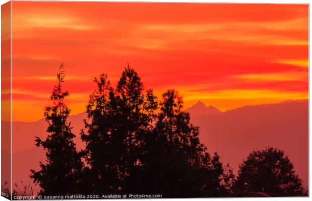 a spectacular sunset over the mountains paints the Canvas Print by susanna mattioda