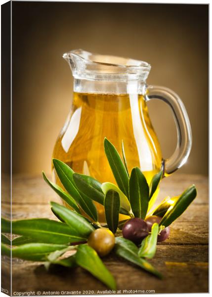 Bottle of olive oil and an olive branch Canvas Print by Antonio Gravante