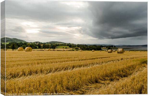 "Dramatic Autumn Harvest: Stormy Barley Straw Bale Canvas Print by Mike Byers