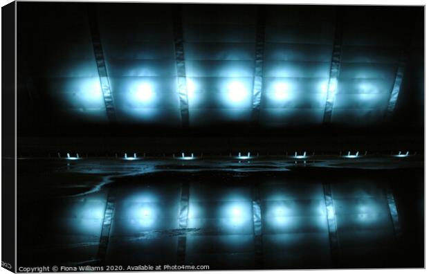 Glasgow Imax lights reflected in the water below Canvas Print by Fiona Williams