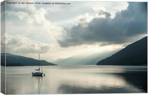Solitary Boat on a tranquil Loch Tay Perthshire Scotland Canvas Print by Iain Gordon