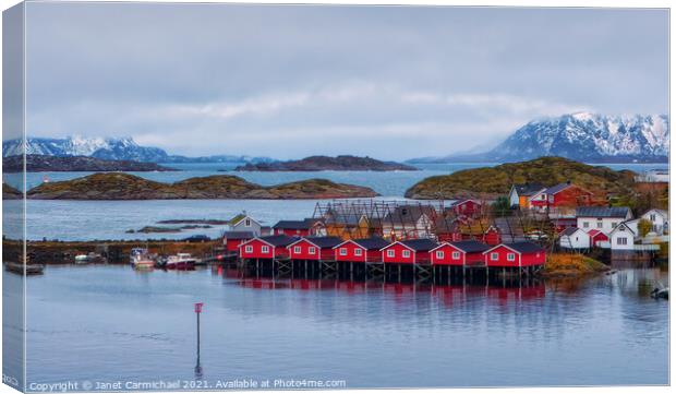 Norwegian Fishermens Houses and Drying Racks Canvas Print by Janet Carmichael