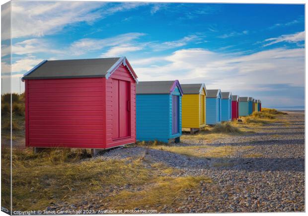 Colourful Beach Huts under Scottish Skies Canvas Print by Janet Carmichael