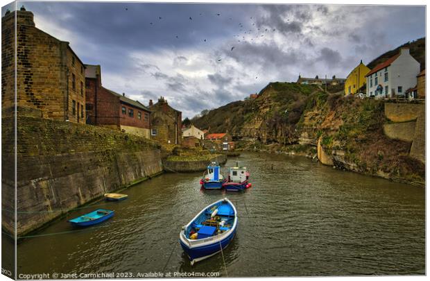 Seagulls Soar Over Stormy Staithes Canvas Print by Janet Carmichael