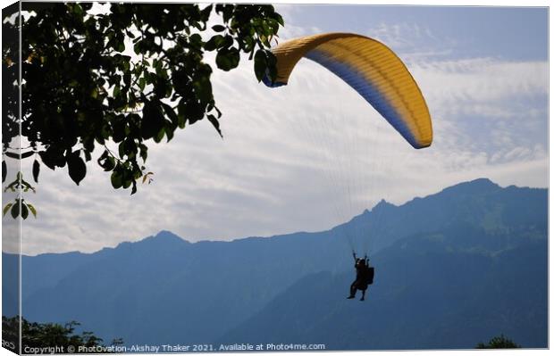 A person flying through the air on top of a mounta Canvas Print by PhotOvation-Akshay Thaker