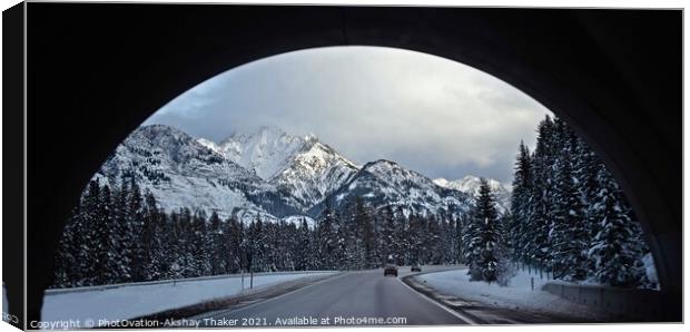 A view of snow covered mountains and roads through an arch. Canvas Print by PhotOvation-Akshay Thaker
