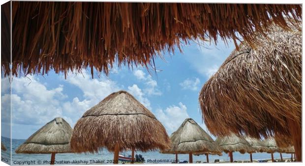 View of ocean through Sunshades at sandy beach in Mexico Canvas Print by PhotOvation-Akshay Thaker
