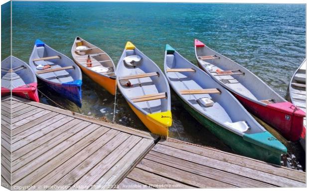 Colorful boats sitting near a wooden dock over some water Canvas Print by PhotOvation-Akshay Thaker