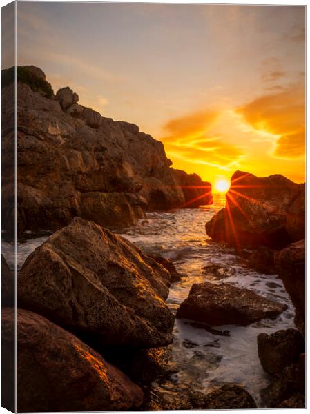 Sunrise between the rocks in a cove of La Renega, Oropesa Canvas Print by Vicen Photo