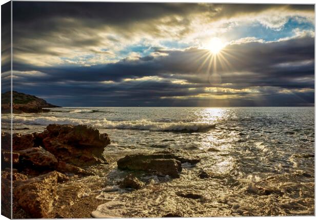 The sunrise sun through the clouds from a small cove Canvas Print by Vicen Photo