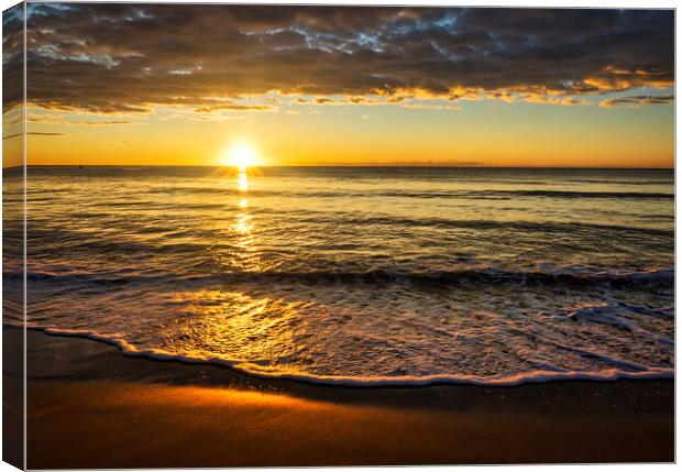 Photography with the sun between the sea and the clouds at a sunrise on the beach Canvas Print by Vicen Photo