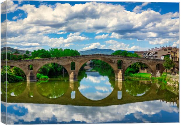 Photography with the Roman bridge and its reflection in the river on the Camino de Santiago Canvas Print by Vicen Photo