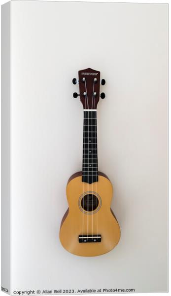  Ukulele hanging on wall Canvas Print by Allan Bell