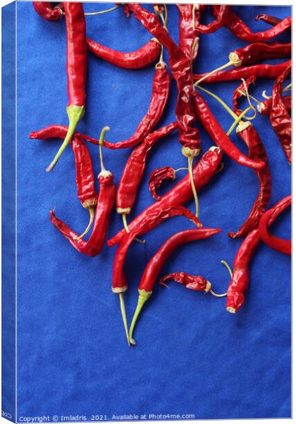 Red Chilli Peppers on Blue Canvas Print by Imladris 