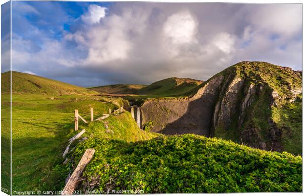 Storm clouds over Speke's Mill Mouth Waterfall Canvas Print by Gary Holpin