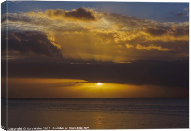 The sun breaking through the cloud cover over the Bristol channel Canvas Print by Rory Hailes