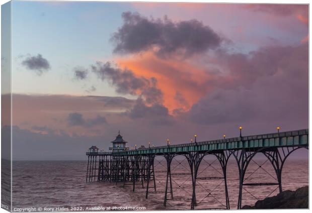 Clevedon Pier at sunset at low tide and choppy sea Canvas Print by Rory Hailes