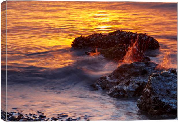 Sunset rocks with a splash Canvas Print by Rory Hailes