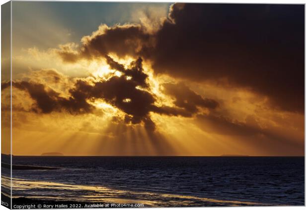 Crepuscular rays breaking through the cloud cover Canvas Print by Rory Hailes