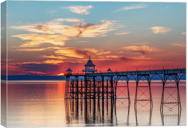 Clevedon Pier at sunset with colourful reflection on the sea Canvas Print by Rory Hailes