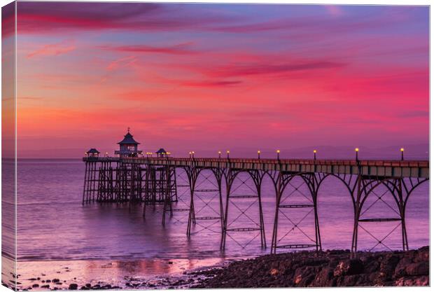 Clevedon Pier at sunset at low tide Canvas Print by Rory Hailes