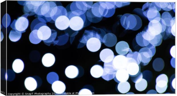 Abstract background of white and blue light halos or circles in a tree Canvas Print by SnapT Photography