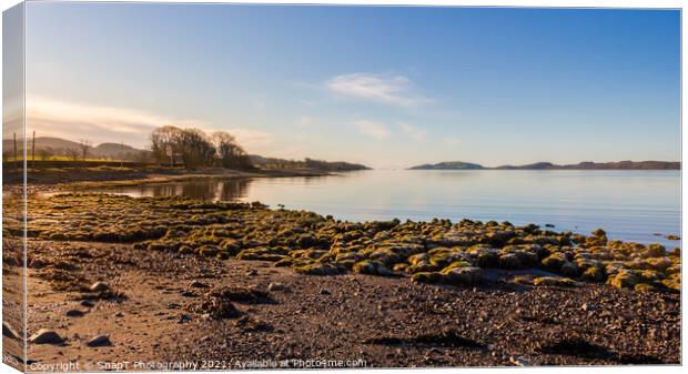 Sunrise on a rocky beach at Kirkcudbright Bay, Dumfries and Galloway, Scotland Canvas Print by SnapT Photography