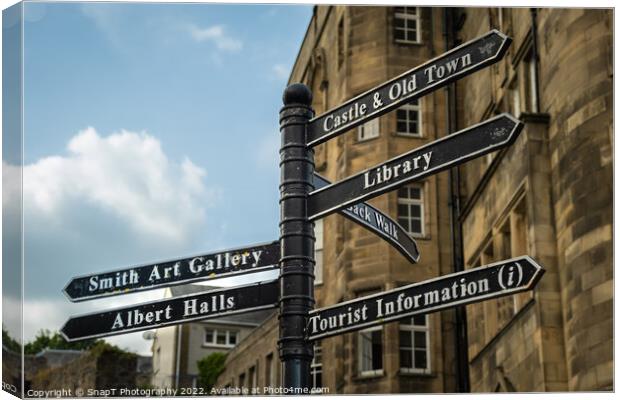 Sign post highlighting the directions to attractions in stirling town centre Canvas Print by SnapT Photography