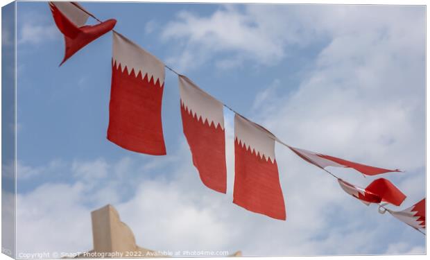 Al-Adaam national flags of Qatar flying in the sky above Doha, Qatar Canvas Print by SnapT Photography