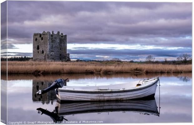 Boat moored on the river dee with Threave Castle in the background, Scotland Canvas Print by SnapT Photography