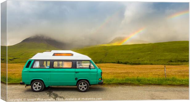 An old green camper van in the shadow of misty mountains and a rainbow Canvas Print by SnapT Photography