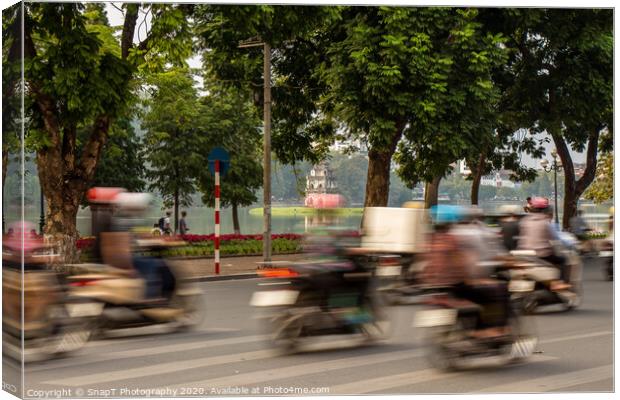 Motorbike motion at Hoan Kiem lake and turtle tower in the background Canvas Print by SnapT Photography